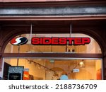 Small photo of Sidestep shoe, clothing, and accessories shop sign in a window. Trier, Rhineland-Palatinate, Germany - February 17, 2021