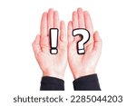 Small photo of Crossed hands holding a large black and white exclamation and question marks isolated on white background. Expression of strong emotions or opinions, sense of urgency and importance, inquiry.