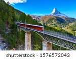 Small photo of Zermatt, Switzerland. Gornergrat red tourist train on the bridge and Matterhorn peal panorama in Swiss Alps