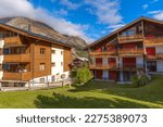 Traditional wooden houses, flowers in Zermatt, alpine village panorama, Switzerland, Swiss Alps and autumn mountains view