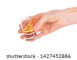 Man's hand holding a glass with  tequila
