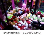 Toy vending machine or claw machine with plush soft toys on display inside for customers to have a fun time trying to grab the prizes with a mechanical claw. Gaming machine at an entertainment outlet.