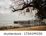 Small photo of Wooden pier at the beach on a rainy day at NusaBay Menjangan by WHM in Bali