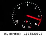 Close up of car dashboard tachometer on blackground. 5000 - 6000 rpm.           