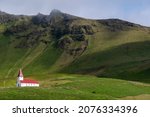 Small photo of Vik, Iceland - August 12th 2021: Landscape of Vik i Myrdal church on hill with grassy cliffs in Vik Iceland