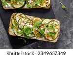 Grilled Zucchini Sandwich, Healthy Vegetarian Sandwich with Zucchini, Arugula, Feta and Pesto Sauce on Dark Background