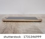 smartphone on a wooden background. Side view.