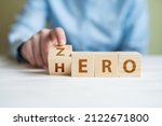 Zero or Hero concept, Hand flip wood cube change the word.women hand flipping cube wooden with text Hero and Zero, Self development and change from loser become to winner concept.