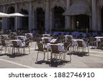 Small photo of idle vacuous cafe tables of empty San Marco fresh blue early morning