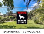 A Beware Of Dog Sign On A Fence ...