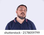 Small photo of A groggy man in his late 30s. Possibly drunk with a hangover, or sleep deprived. Looking a bit funny. Isolated on a white background.