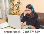 Small photo of A pretty virtual assistant listens carefully to her clients grievances or comments. An inbound call center agent working remotely at home.