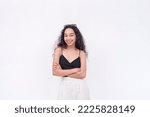 Small photo of A cute and genial Filipino woman smiling with her arms crossed. Wearing a black spaghetti strap blouse. Isolated on a white background.