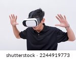 Small photo of A young man awestruck by the VR environment displayed on his virtual reality headset. Isolated on a white backdrop.