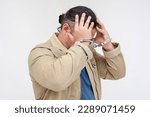 Small photo of A stressed man in handcuffs laments his wrongdoings. Under arrest and detained for a suspected crime. Isolated on a white background.