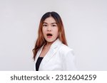 Small photo of An appalled and surprised young asian woman looking at the camera in disbelief and rendered speechless. Isolated on a white background.