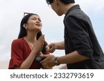 Small photo of A young woman begs for forgiveness after being caught cheating by her boyfriend over salacious and flirty chats with another man on her cellphone.