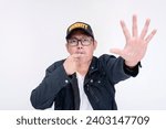 Small photo of Security personnel blowing his whistle while commanding someone to stop and freeze. Gesturing with palm to halt, conveying a restricted area. Isolated on a white background.