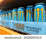 Small photo of Philippines - Sept 17, 2023: Brightly colored cans of Mango Loco Juiced Monster energy drink aligned on a retail shelf, showcasing a colorful design.