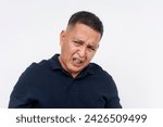 Small photo of A revolted middle aged Asian man displaying a disgusted expression, isolated on a white background conveying repulsion. Seeing something hideous and repulsive.