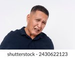 Small photo of A revolted middle aged Asian man looks repulsed and grossed out, isolated on a white background conveying repulsion.