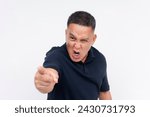Small photo of An intense middle aged Asian man pointing angrily at an unseen person, showing a strong emotional outburst.