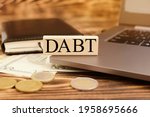 Small photo of Wooden blocks with the word Debt. Reduction or restructuring of debt. Refusal to pay debts or loans and invalidate them. High quality photo