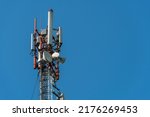 Small photo of New GSM antennas on a high tower against a blue sky for transmitting a 5g signal are dangerous to health. Radiation pollution of the environment through cell towers. The threat of extinction