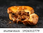 British duck pie on rustic dark background