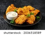 Crunchy cornflakes Chicken with mustard honey sauce on black plate