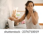 Small photo of Happy Latin American curly haired woman chef kissing fingers, showing tasty hands sign, saying bellissimo while cooking gourmet food in the home kitchen. People. Culinary. Alimentation. Lifestyle