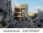 Small photo of Palestinians search the ruins of a building where Khaled Mansour, the leader of the Islamic Jihad movement, was killed in an Israeli air strike, in Rafah in the southern Gaza Strip, on August 7, 2022.