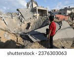 Small photo of Palestinians search a house after an Israeli air strike, in the city of Rafah, southern of the Gaza Strip, on October 17 2023.