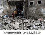 Small photo of Palestinians inspect their destroyed house after an Israeli air strike in the city of Rafah in the southern Gaza Strip, January 14, 2024.