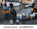 Small photo of Displaced Palestinians fill pots with potable water from the United Nations headquarters, UNRWA, in the city of Rafah in the southern Gaza Strip, on January 29, 2024.