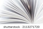 Small photo of Pages of an open book close-up photography. White pages book side view. The concept of continuing education, visiting libraries, book exhibitions.