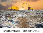 Small photo of garbage dump pile in trash dump or landfill,backhoe and truck is dumping the gabage from municipal,garbage dump pile and dark sky background ,pollution concept