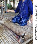Small photo of Cotton spinning process female blue cloth hand and finger Bamboozle bed rotation