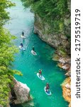 Small photo of Paddleboarding in the The Great Soca Gorge, Beautiful gorge with emerald coloured water flowing between the uniquely formed rocks, Triglav National Park, Julian Alps, Slovenia, Europe 05.06.2022