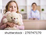 Little girl with teddy bear is...