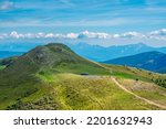 A footpath that skirts the green grassy peak of Rindernock (2024m.), Nock Mountains, Gurktal Alps, Austria.