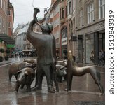 Small photo of BREMEN, GERMANY, August 18, 2019: Exterior of the statue of the Swineherd with a dog and pigs in Bremen, Germany.