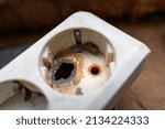 Small photo of Poor quality electrical connector. Failure to comply with safety rules. Burnt and melted outlet hole close-up