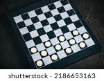 Checkers board with chips black ...