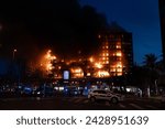 Small photo of Valencia, Spain - February 22, 2024: Police cordon off the area due to a large fire in a 14-storey residential building in the city of Valencia, which quickly burns to the ground