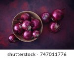 Red onions in a wooden bowl. Food Ingredients. 