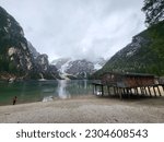Lago di Braies in the Dolomites seen from the beach on a bad weather day