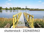 Small photo of Empty yellow boat landing pier jetty at dutch sluis, Maas river - Sambeek sluice, Netherlands