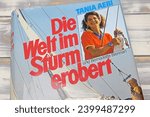 Small photo of Viersen, Germany - May 9. 2023: Tania Aebi travel report book about first youngest woman solo circumnavigation of the globe in the 80s (focus on upper third)