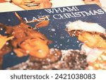 Small photo of Viersen, Germany - January 9. 2024: Closeup of band Wham vinyl record single cover Last christmas from 1984 (focus on center on lower white lettering)